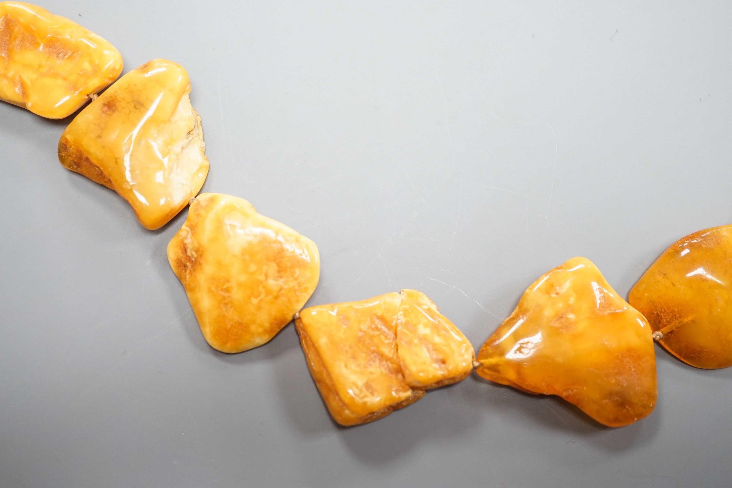 A graduated amber pebble necklace, 56cm gross weight 79 grams, (a.f.).